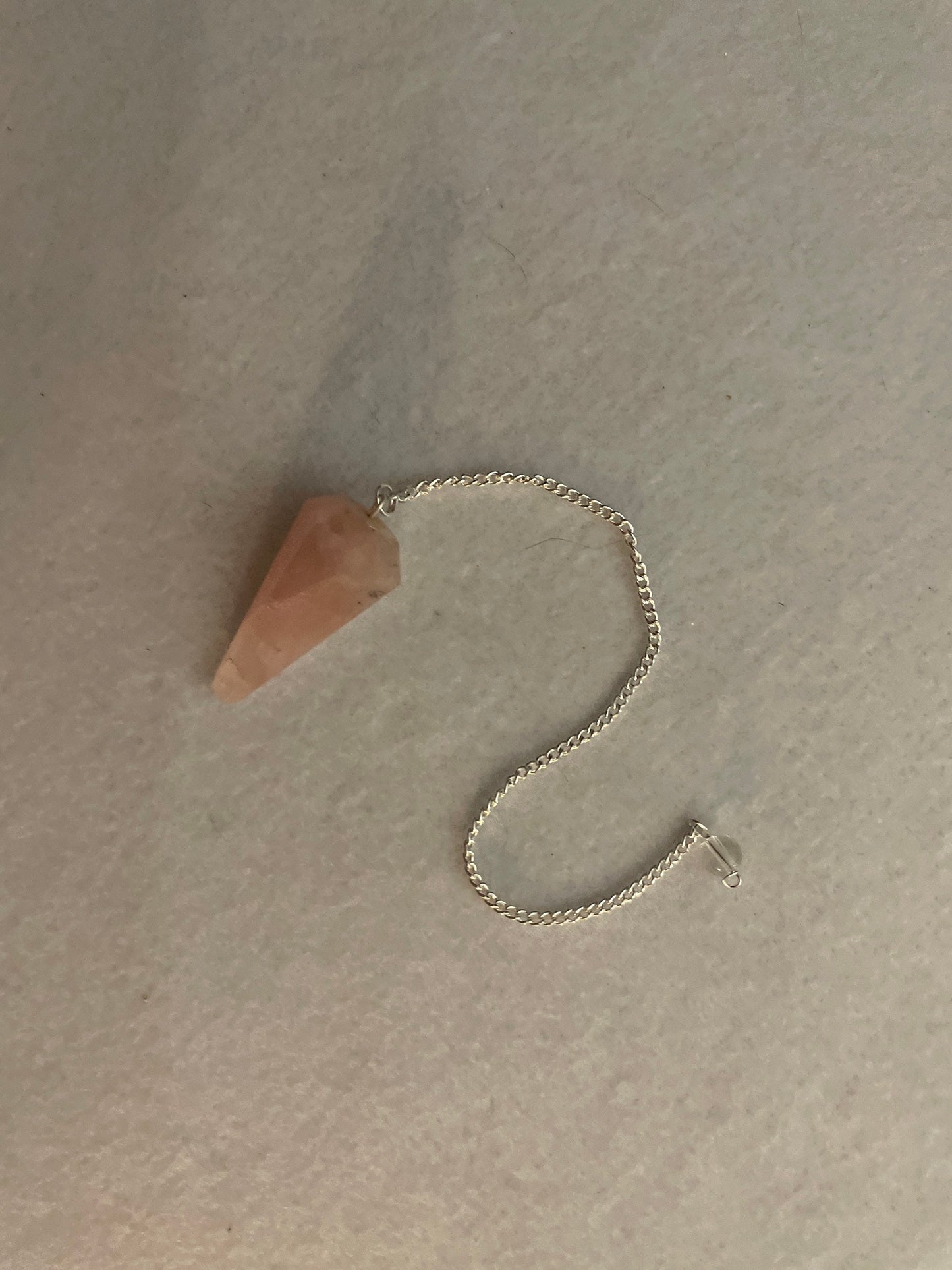 This beautiful Rose Quartz Pendulum is 1.5” and with chain is 8”