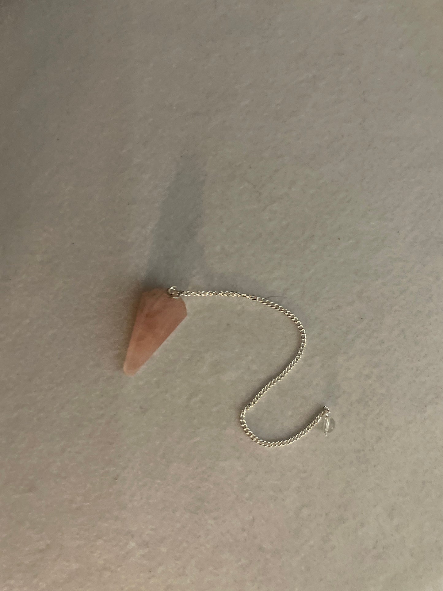This beautiful Rose Quartz Pendulum is 1.5” and with chain is 8”