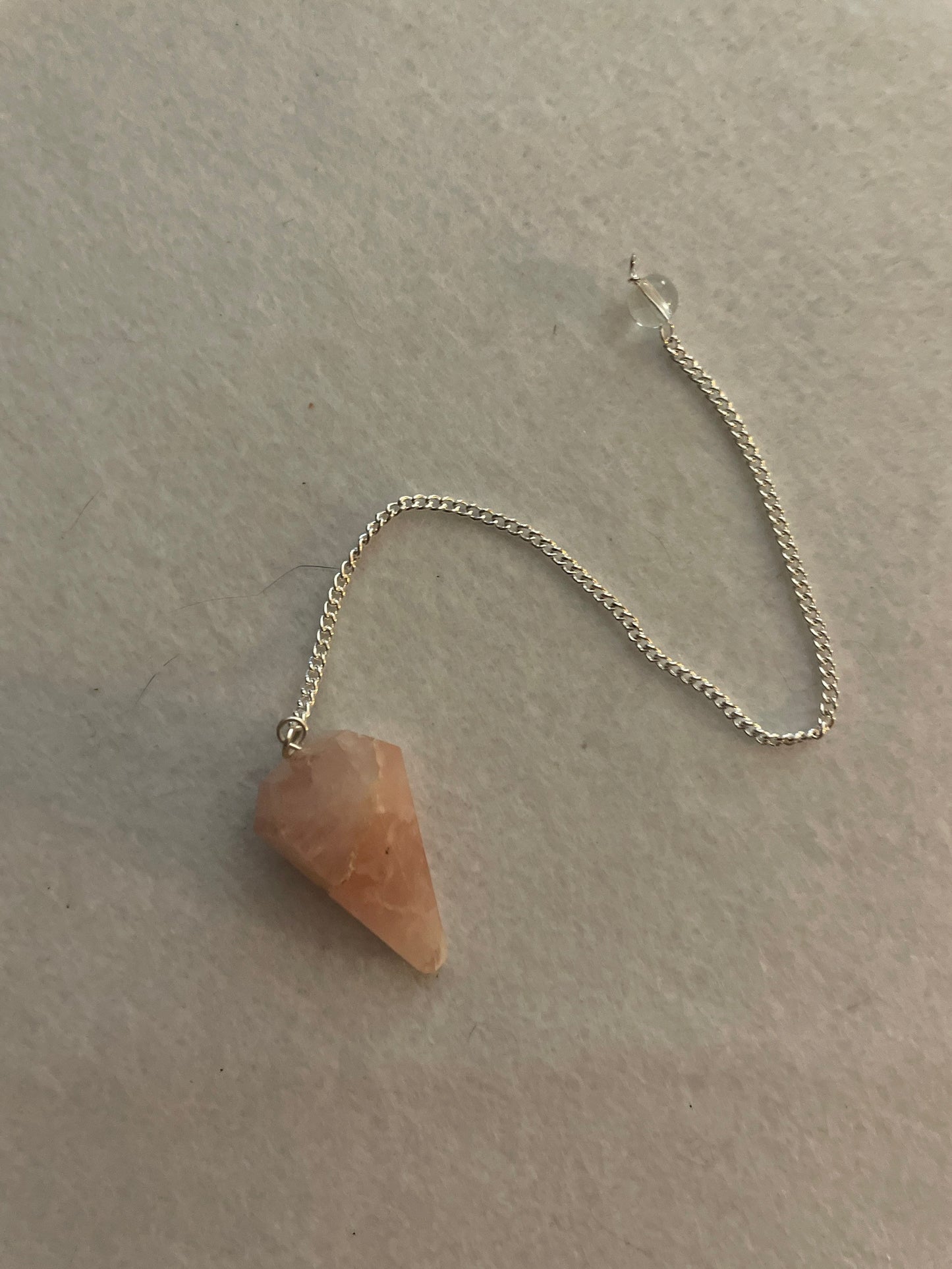 This beautiful Rose Quartz Pendulum is 1.35” and with chain is 8”