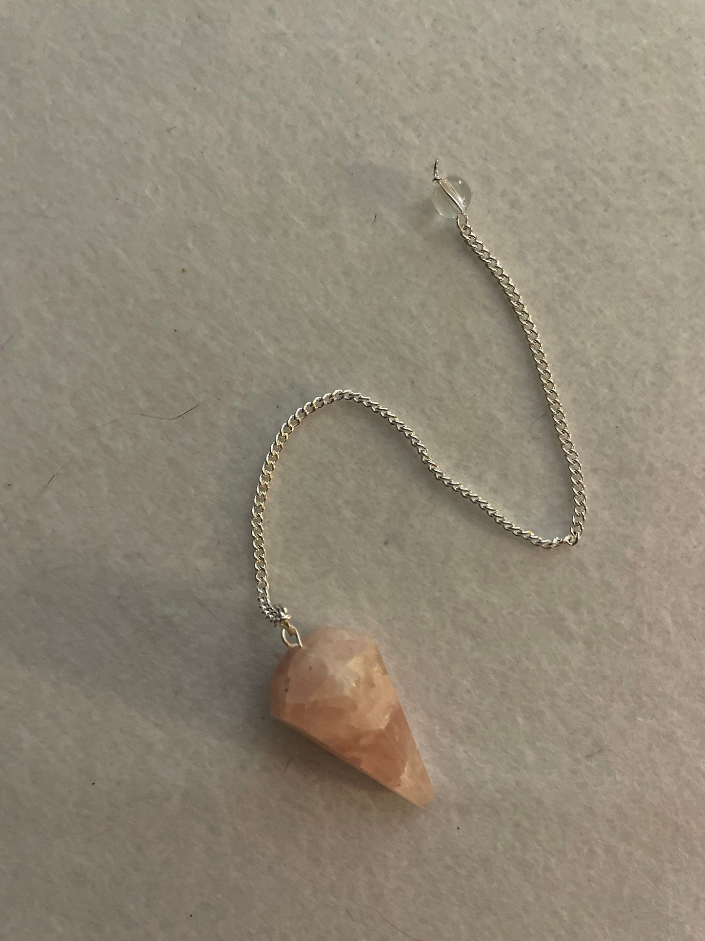 This beautiful Rose Quartz Pendulum is 1.35” and with chain is 8”