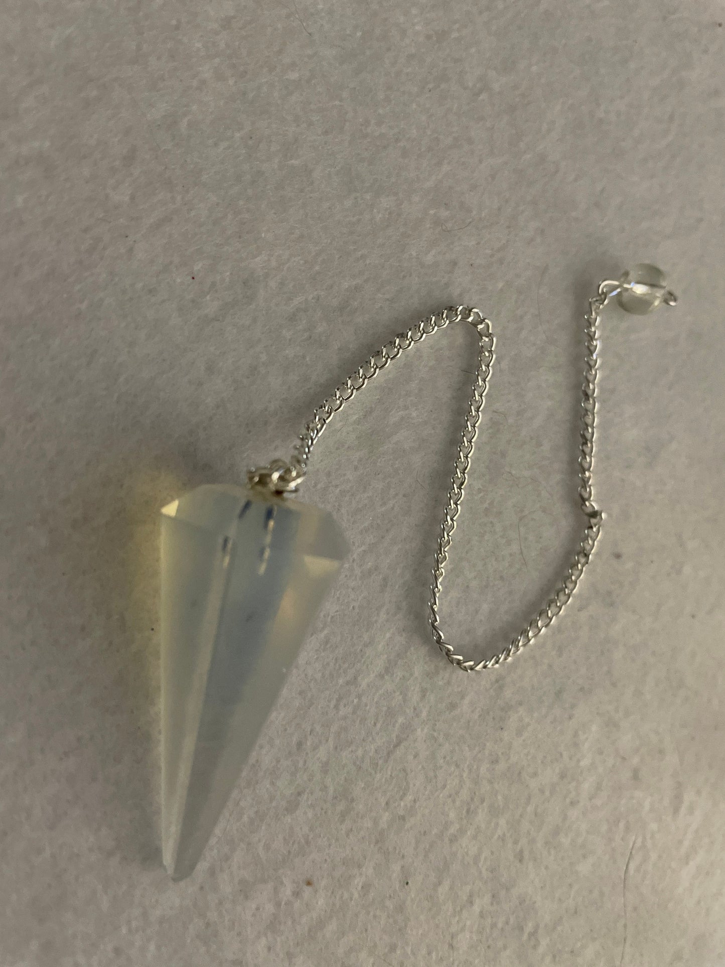 This beautiful  Opalite pendulum is approximately 1.5” and with chain is 8.25”