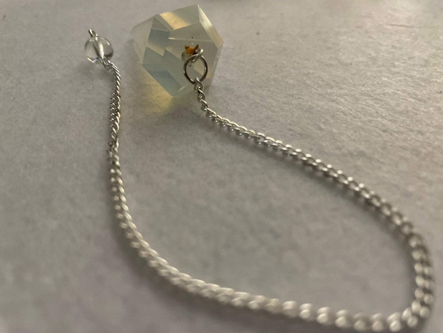 This beautiful  Opalite pendulum is approximately 1.5” and with chain is 8.25”