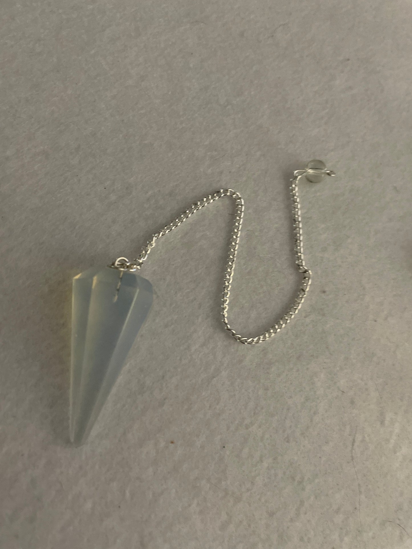 This beautiful  Opalite pendulum is approximately 1.5” and with chain is 8.25”