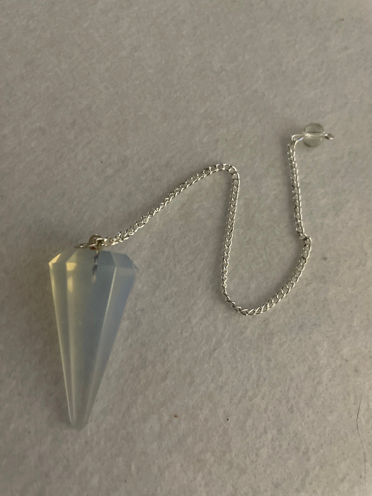 This beautiful  Opalite pendulum is approximately 1.5” and with chain is 8.25”