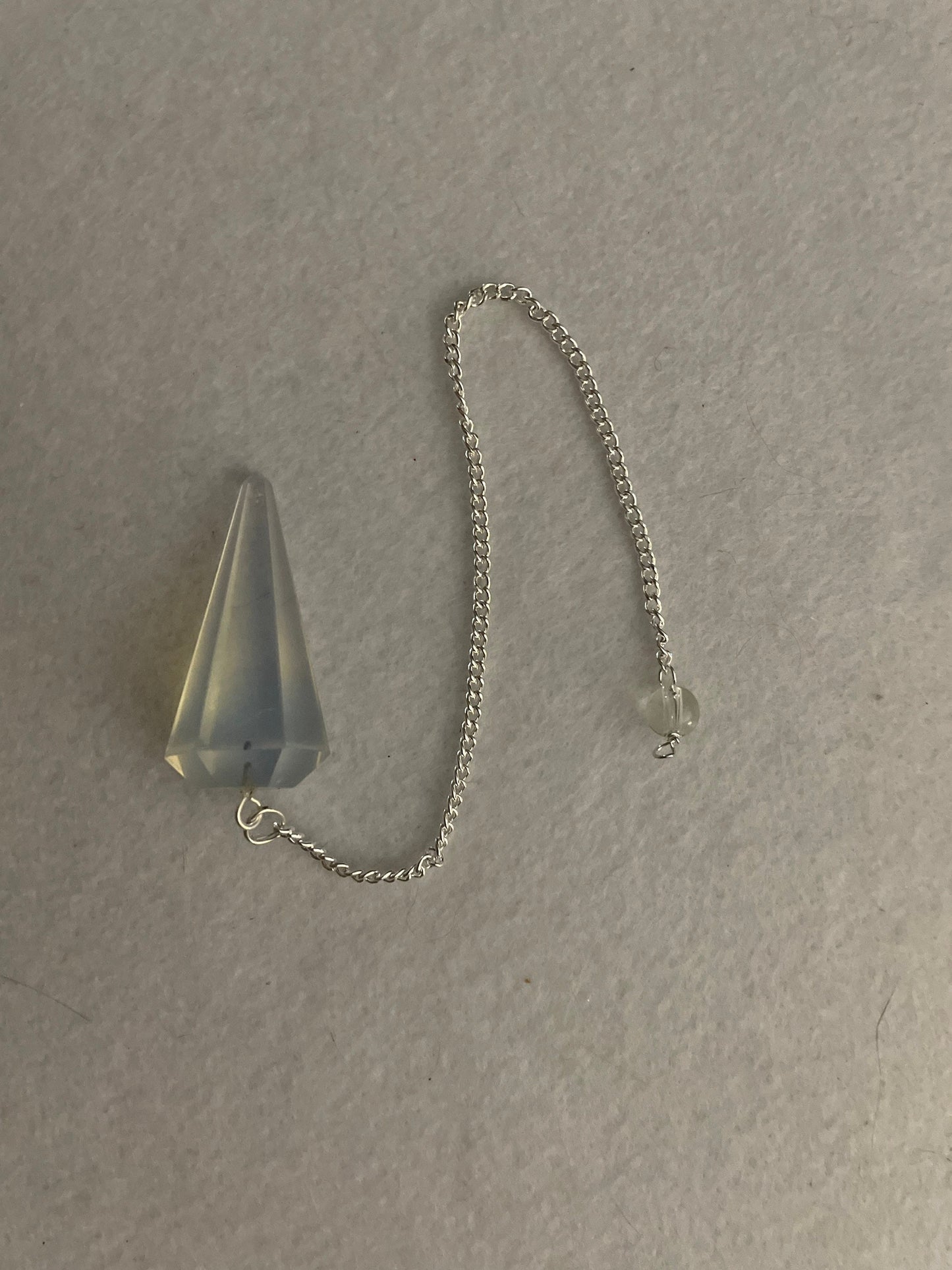 This beautiful  Opalite pendulum is approximately 1.5” and with chain is 8.25”
