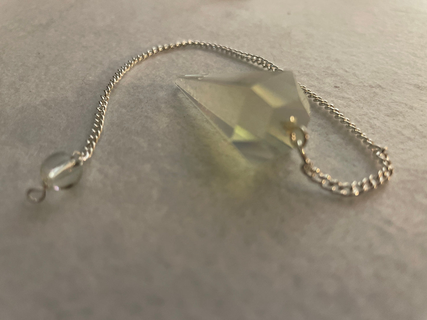 This beautiful  Opalite pendulum is approximately 1.5” and with chain is 8.25”