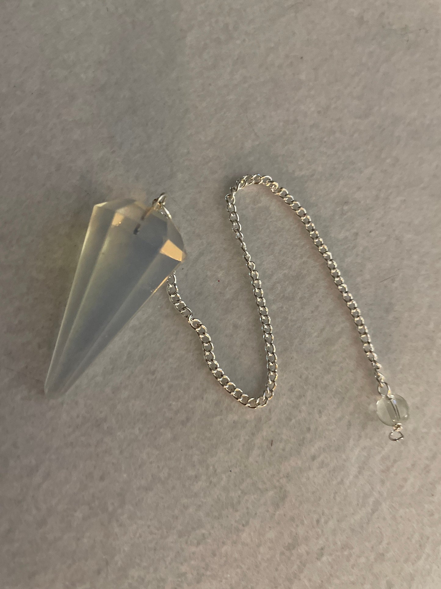 This beautiful  Opalite pendulum is approximately 1.5” and with chain is 8.25”