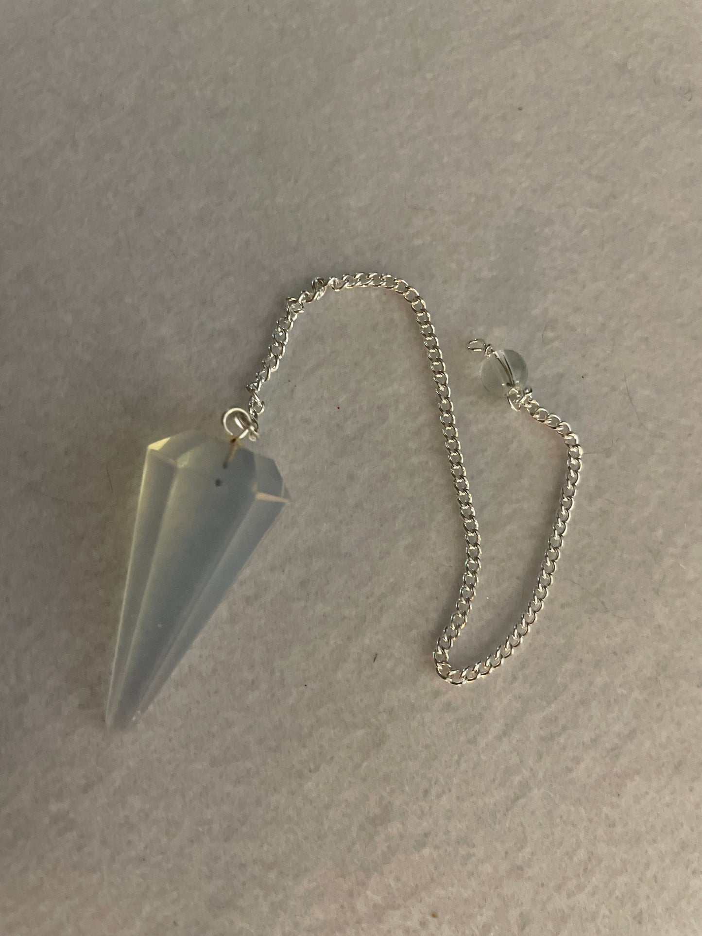 This beautiful  Opalite pendulum is approximately 1.5” and with chain is 8.25”