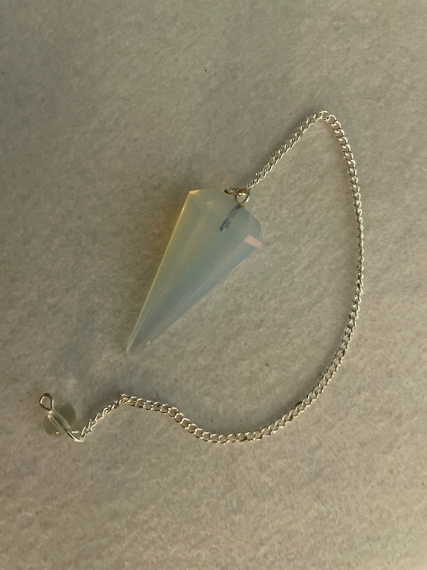 This beautiful  Opalite pendulum is approximately 1.65” And with chain is 8.5”