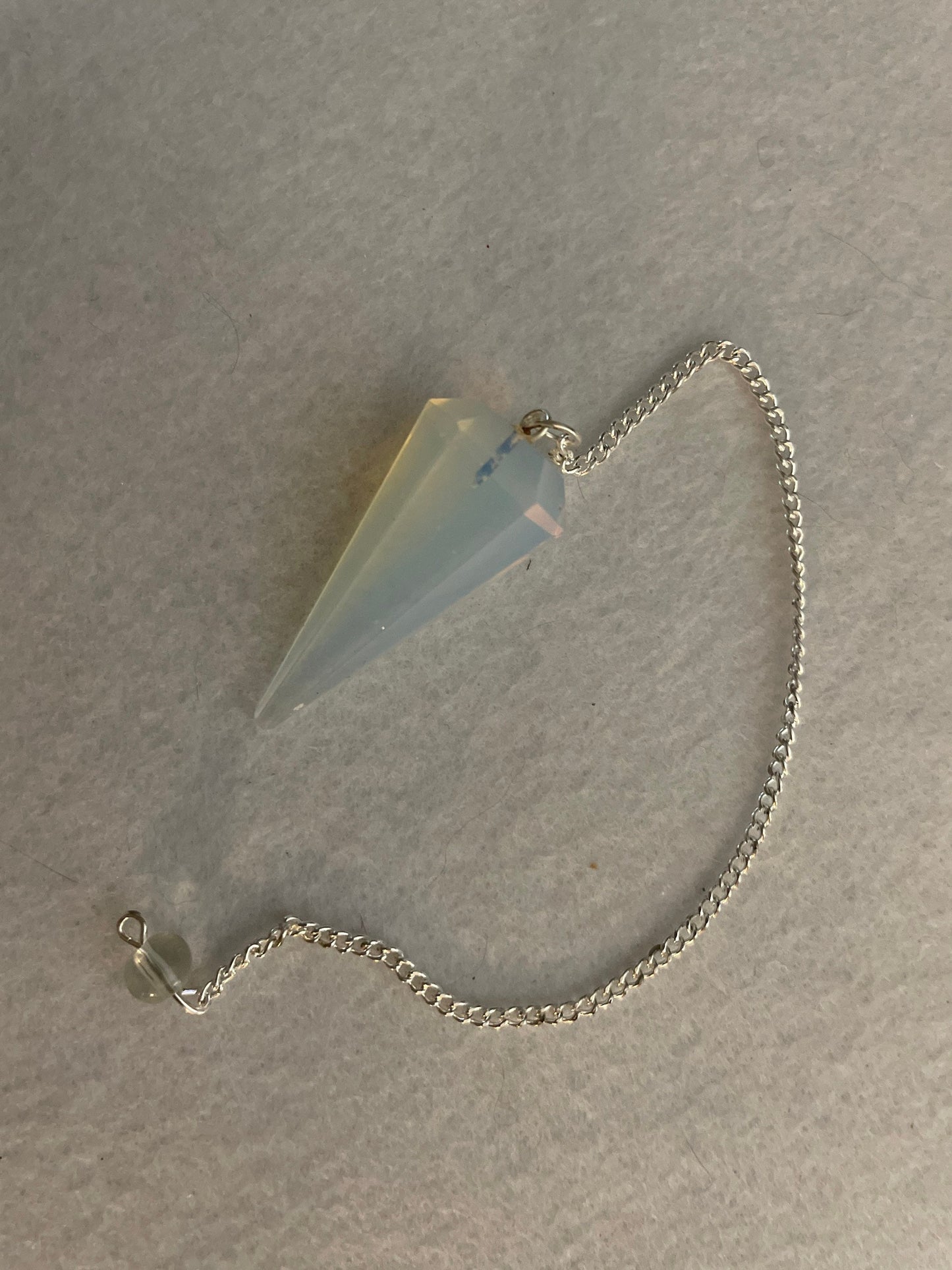 This beautiful  Opalite pendulum is approximately 1.65” And with chain is 8.5”