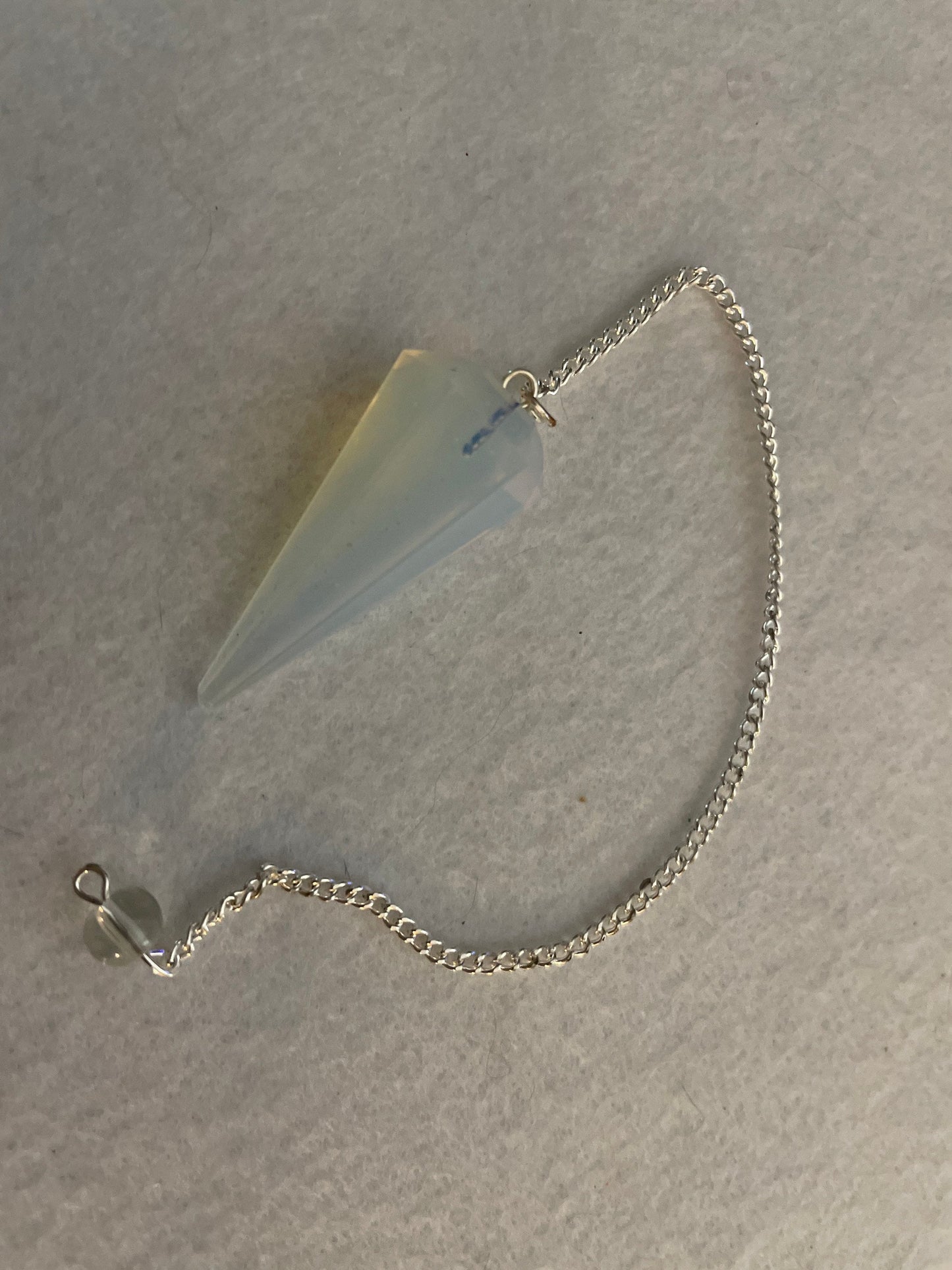 This beautiful  Opalite pendulum is approximately 1.65” And with chain is 8.5”