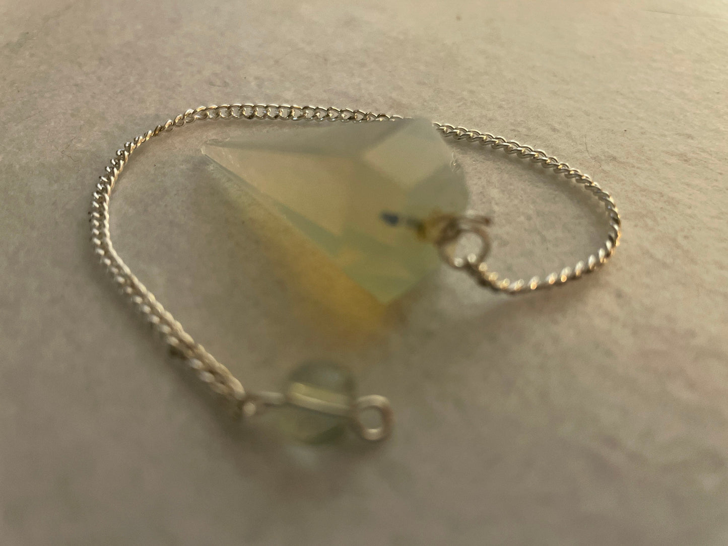 This beautiful  Opalite pendulum is approximately 1.65” And with chain is 8.5”
