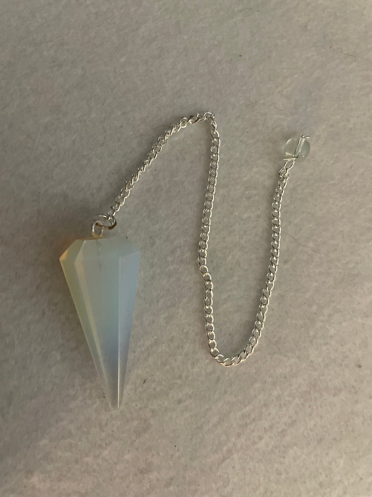 This beautiful  Opalite pendulum is approximately 1.65” and with chain is 8.5”