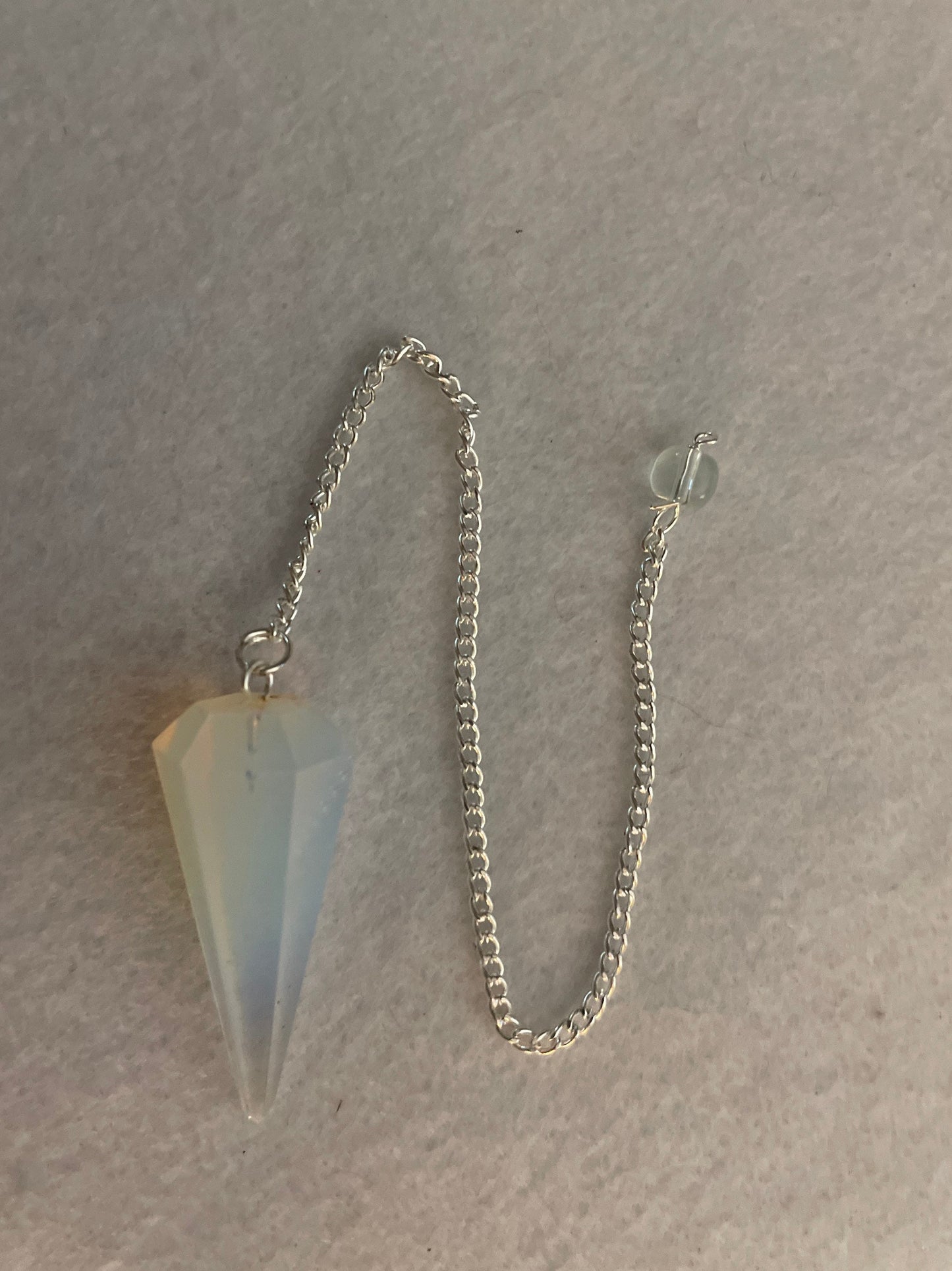 This beautiful  Opalite pendulum is approximately 1.65” and with chain is 8.5”