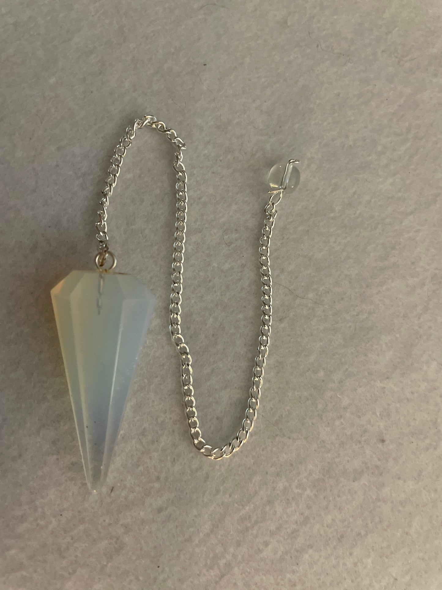 This beautiful  Opalite pendulum is approximately 1.65” and with chain is 8.5”