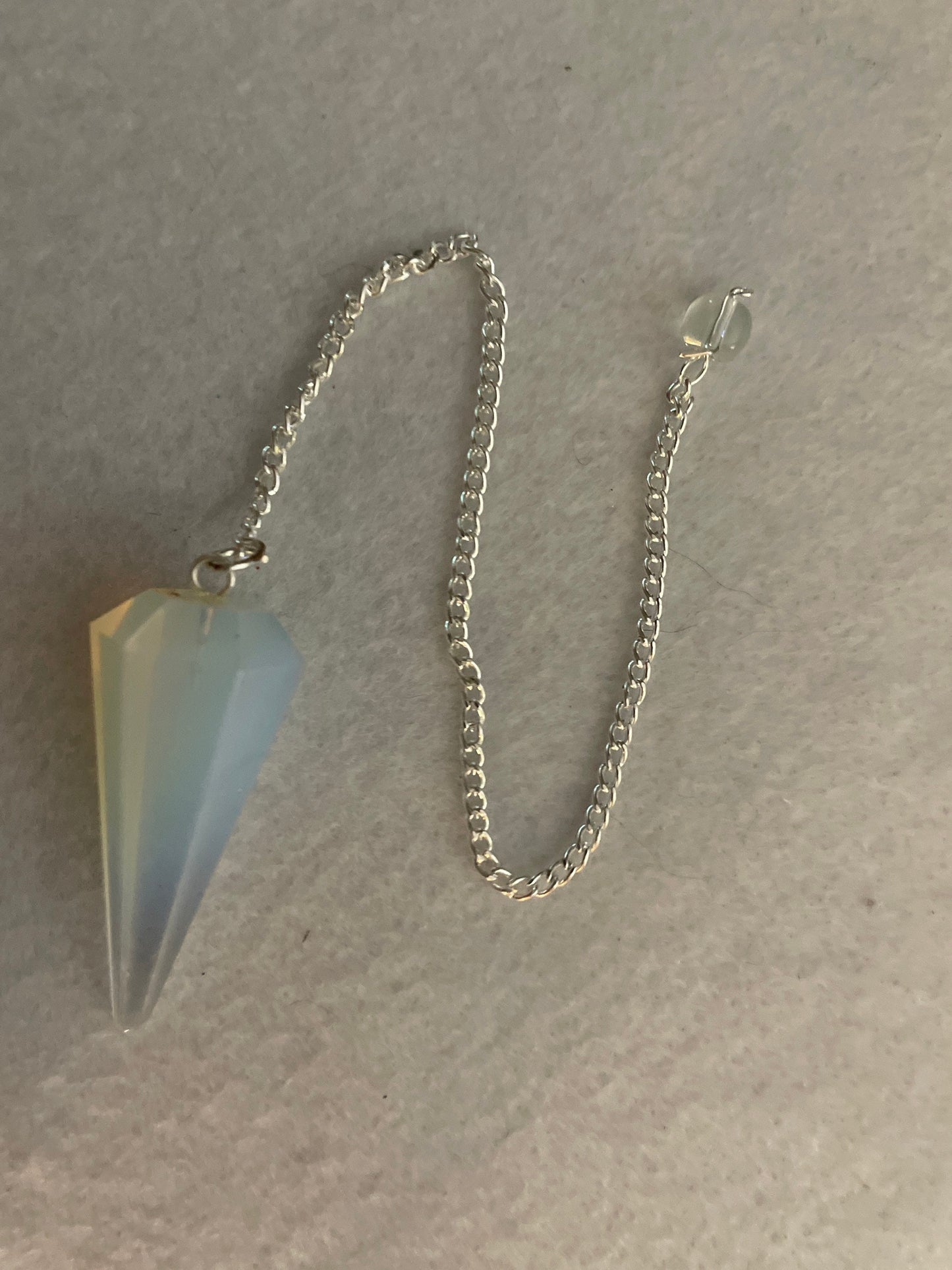 This beautiful  Opalite pendulum is approximately 1.65” and with chain is 8.5”