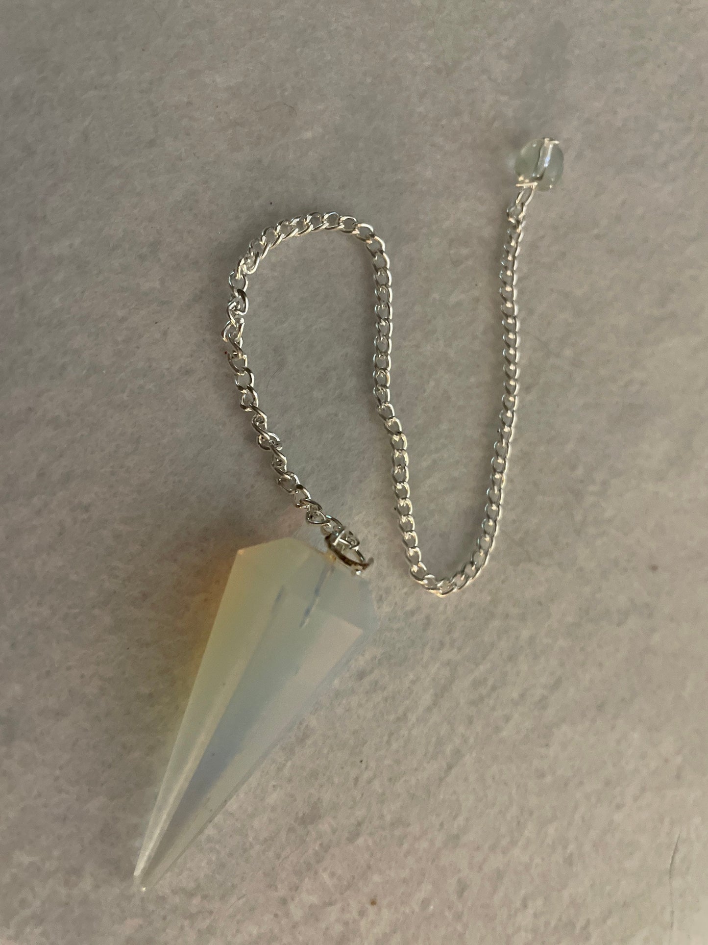 This beautiful  Opalite pendulum is approximately 1.65” and with chain is 8.5”