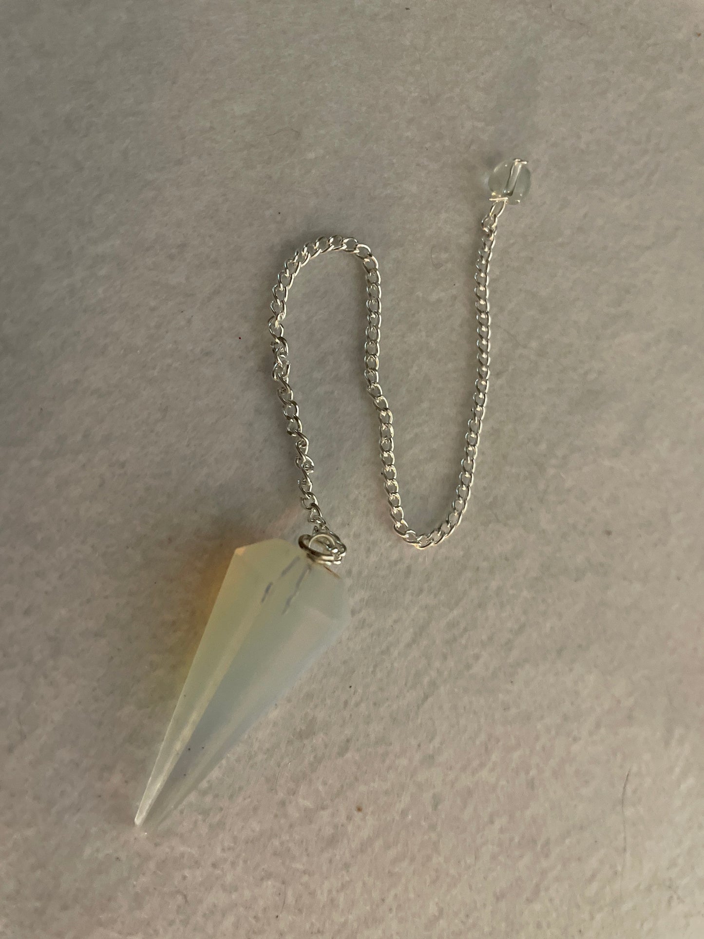 This beautiful  Opalite pendulum is approximately 1.65” and with chain is 8.5”