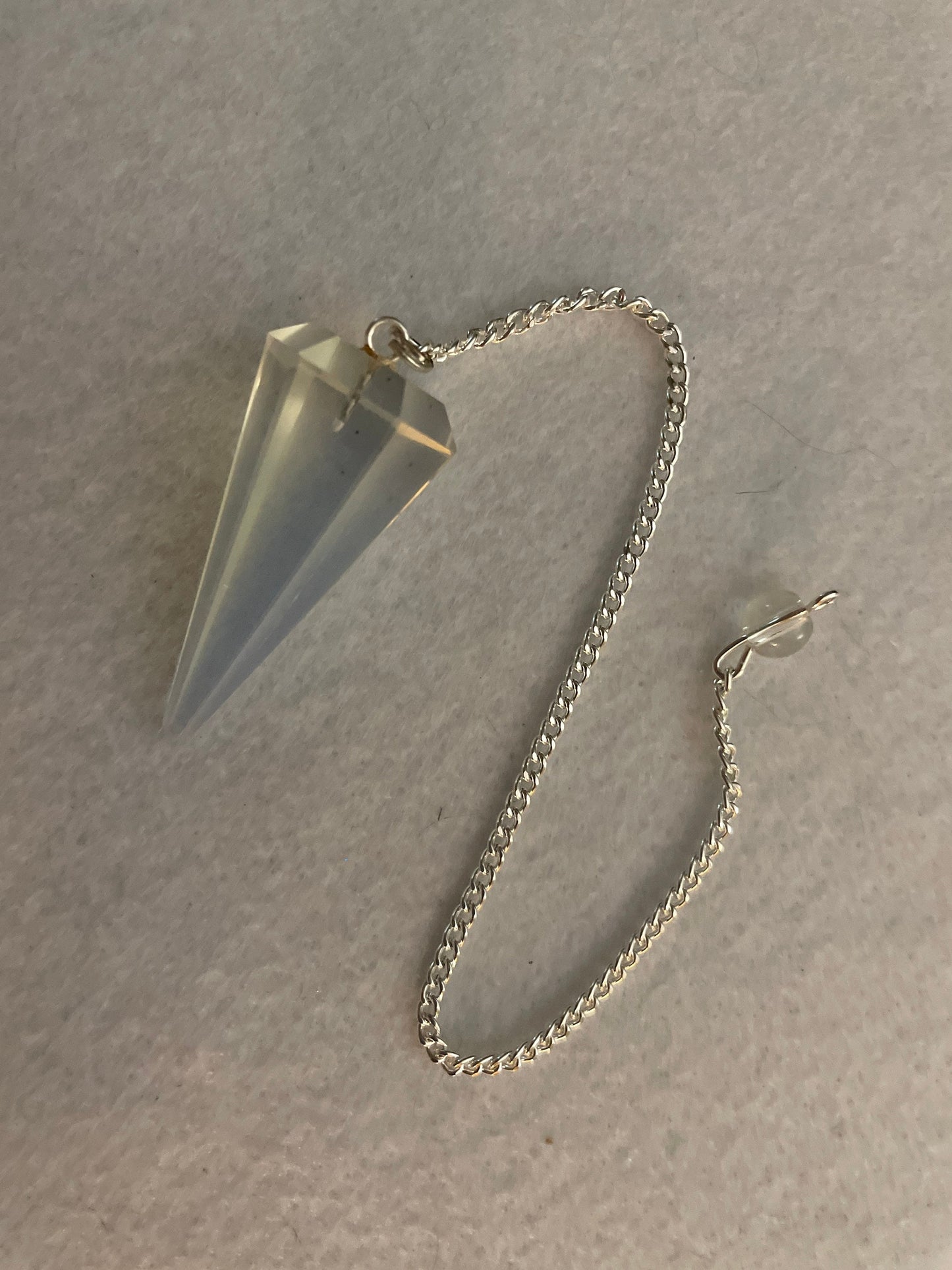 This beautiful  Opalite pendulum is approximately 1.65” and with chain is 8.5”
