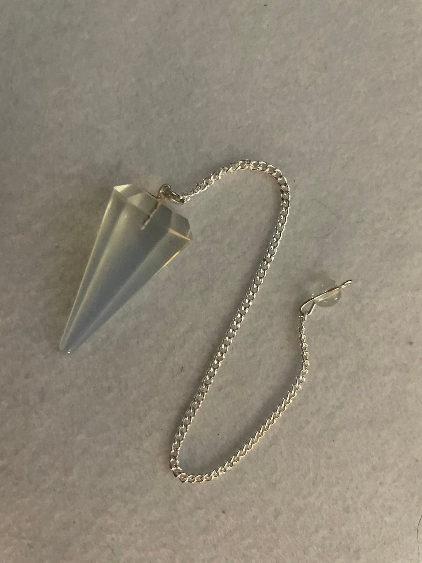 This beautiful  Opalite pendulum is approximately 1.65” and with chain is 8.5”
