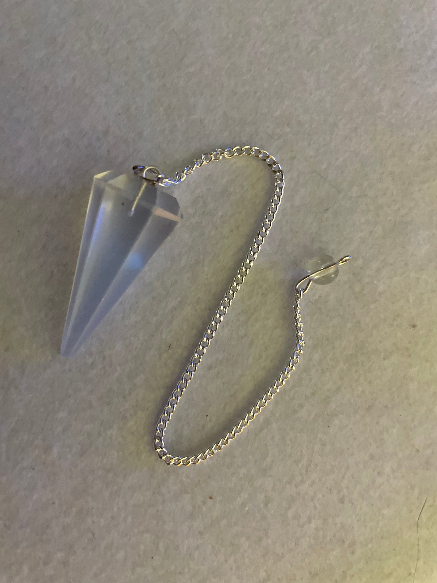 This beautiful  Opalite pendulum is approximately 1.65” and with chain is 8.5”