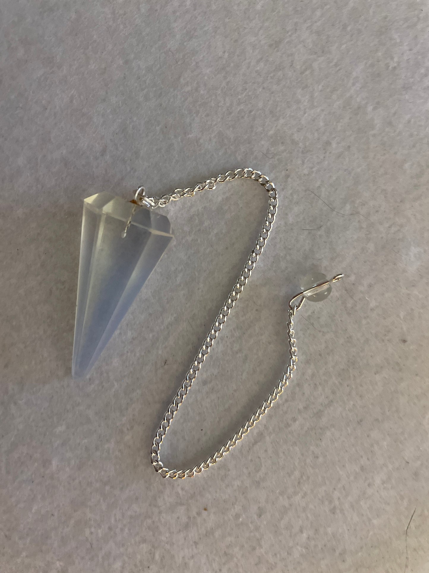 This beautiful  Opalite pendulum is approximately 1.65” and with chain is 8.5”