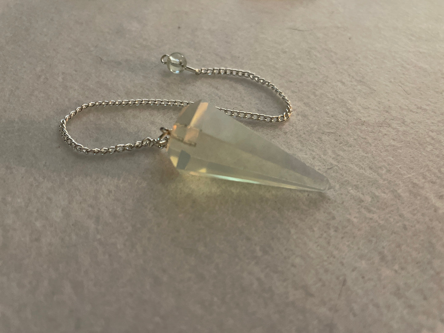 This beautiful  Opalite pendulum is approximately 1.65” and with chain is 8.5”