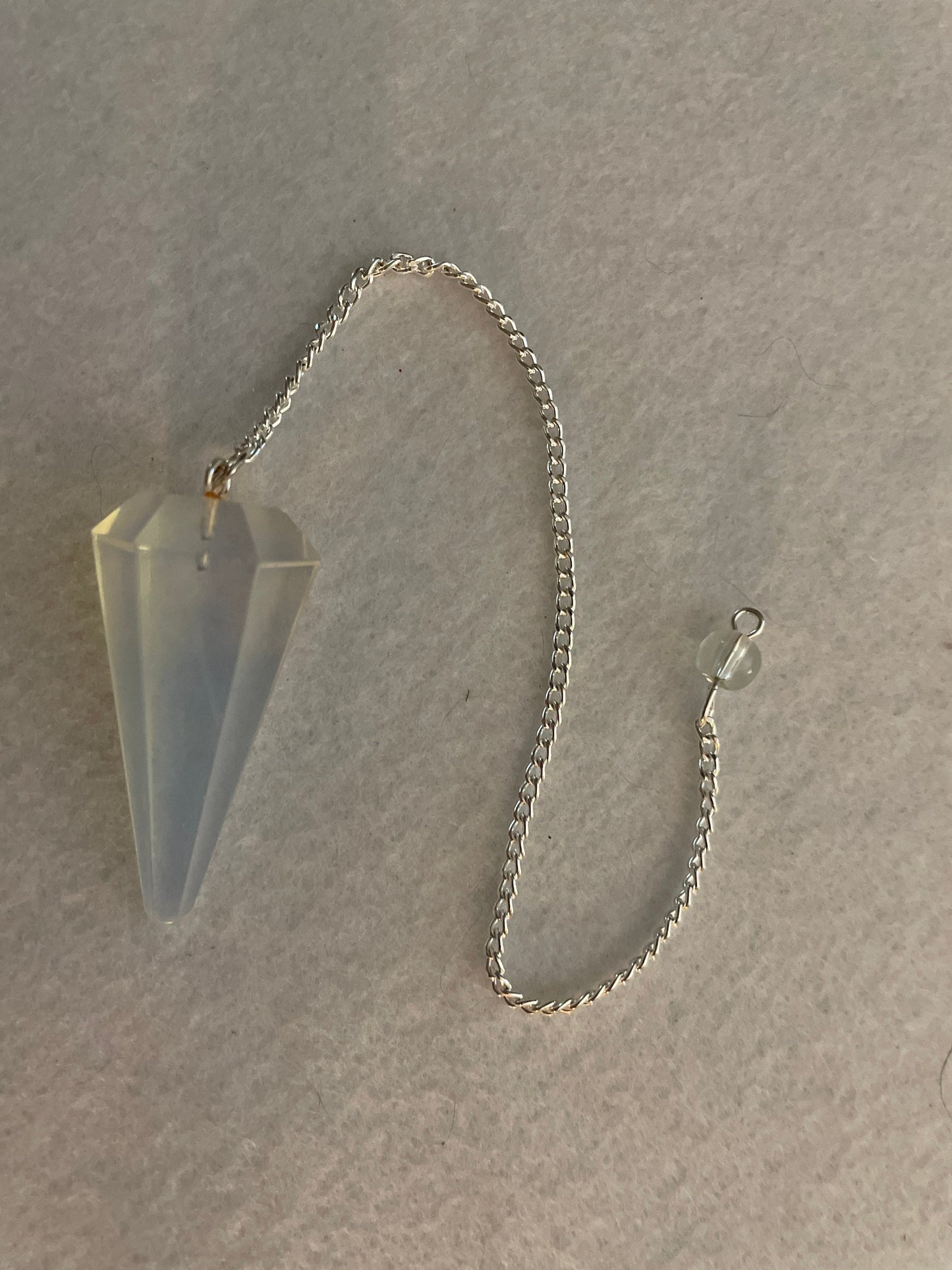 This beautiful  Opalite pendulum is approximately 1.65” and with chain is 8.5”