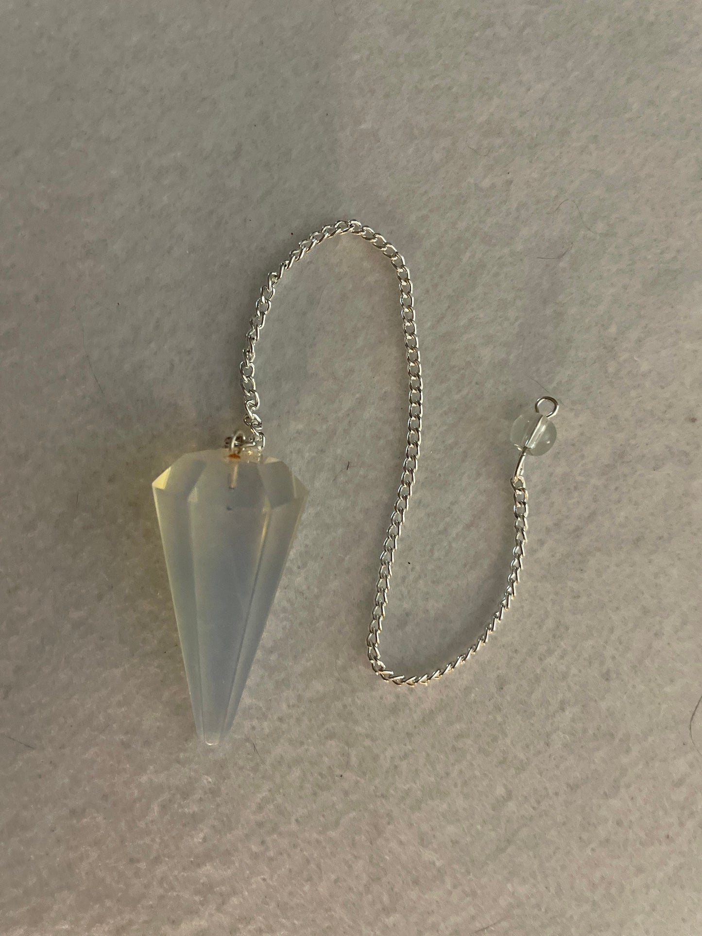 This beautiful  Opalite pendulum is approximately 1.65” and with chain is 8.5”