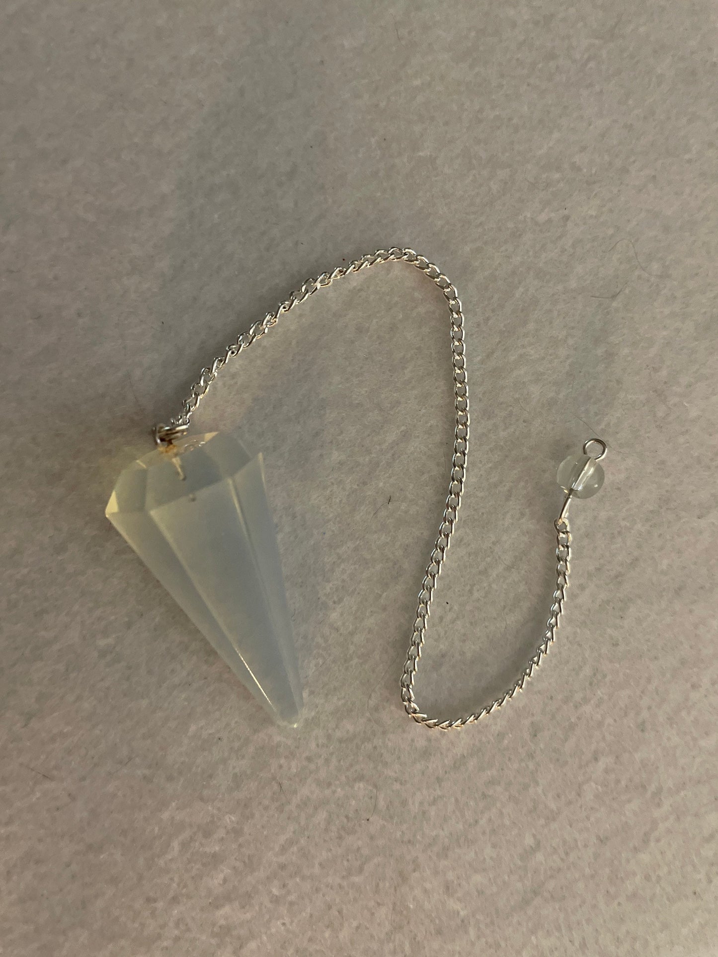 This beautiful  Opalite pendulum is approximately 1.65” and with chain is 8.5”