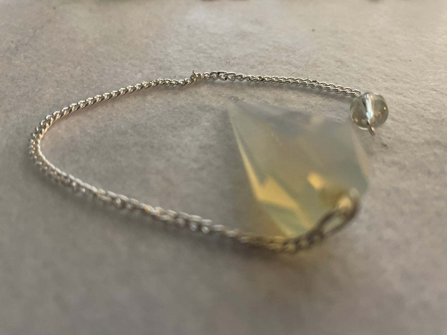 This beautiful  Opalite pendulum is approximately 1.65” and with chain is 8.5”
