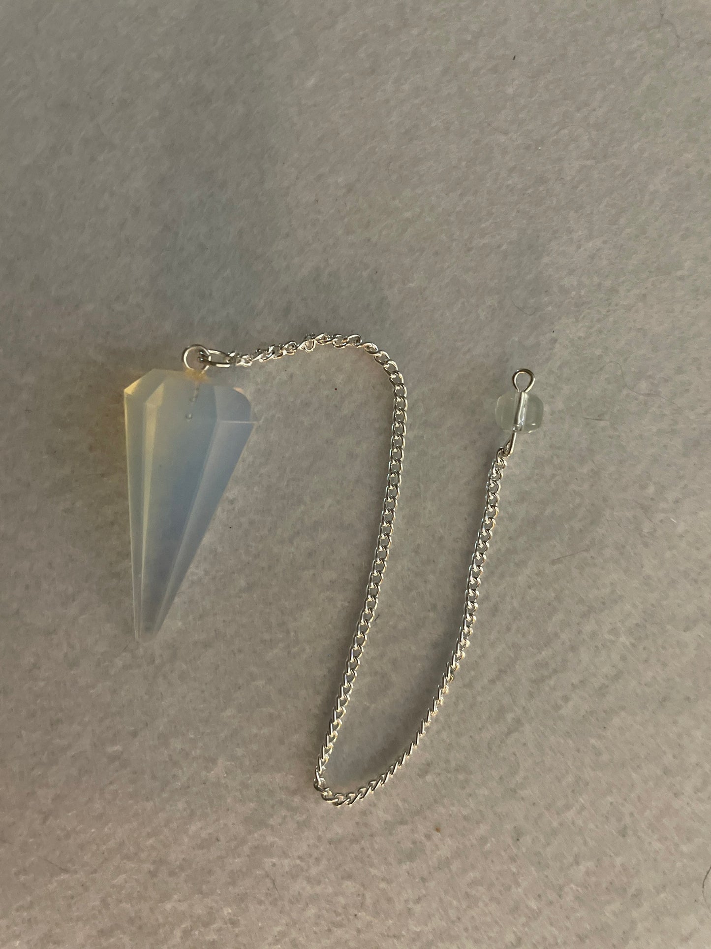 This beautiful  Opalite pendulum is approximately 1.65” and with chain is 8.5”