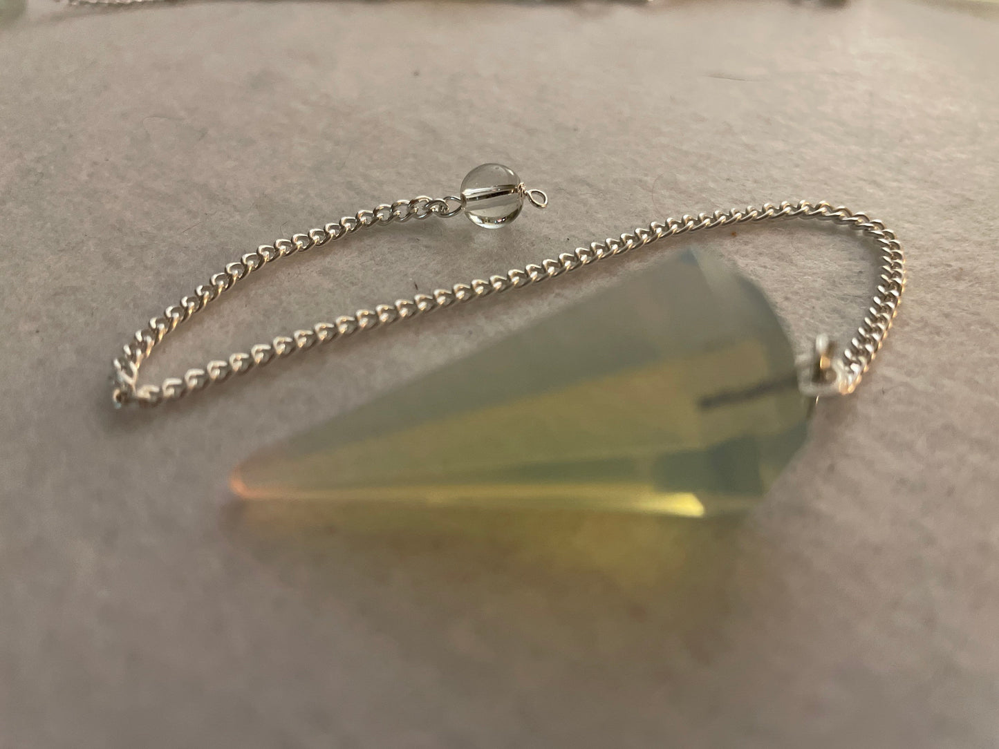 This beautiful  Opalite pendulum is approximately 1.65” and with chain is 8.5”