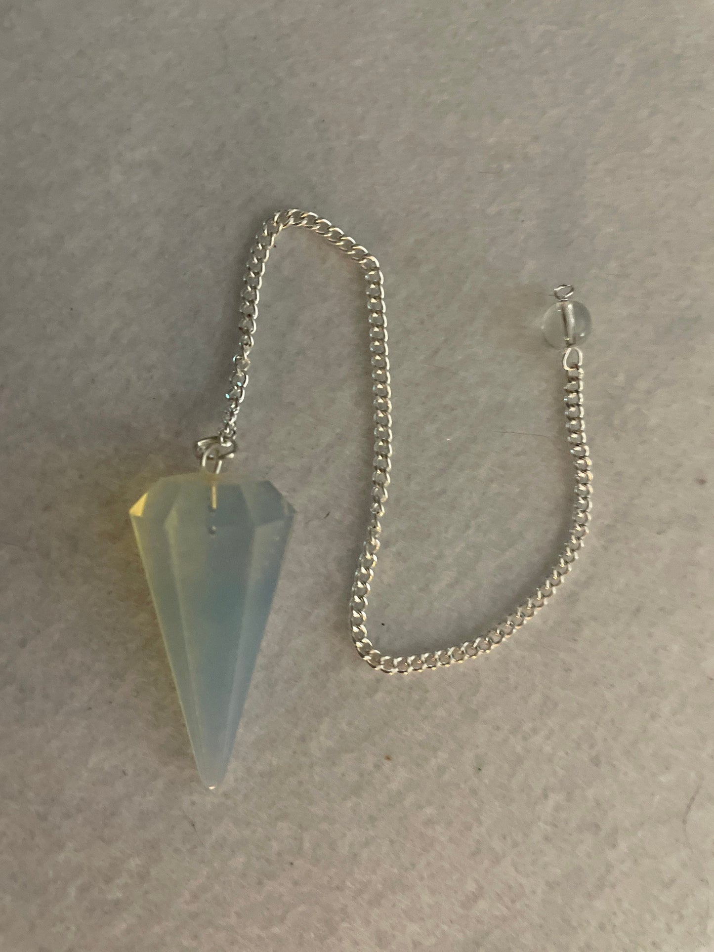 This beautiful  Opalite pendulum is approximately 1.65” and with chain is 8.5”