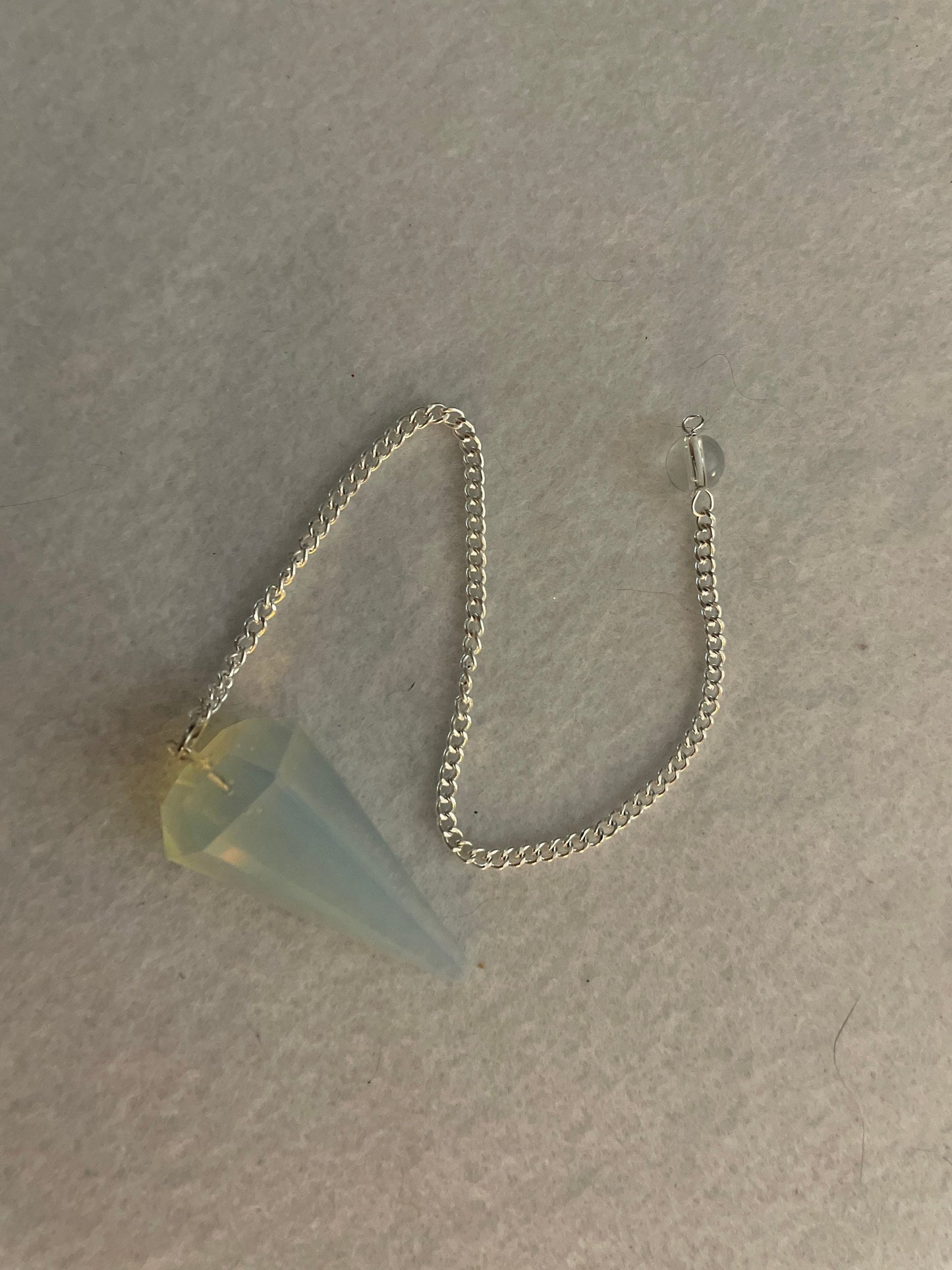 This beautiful  Opalite pendulum is approximately 1.65” and with chain is 8.5”
