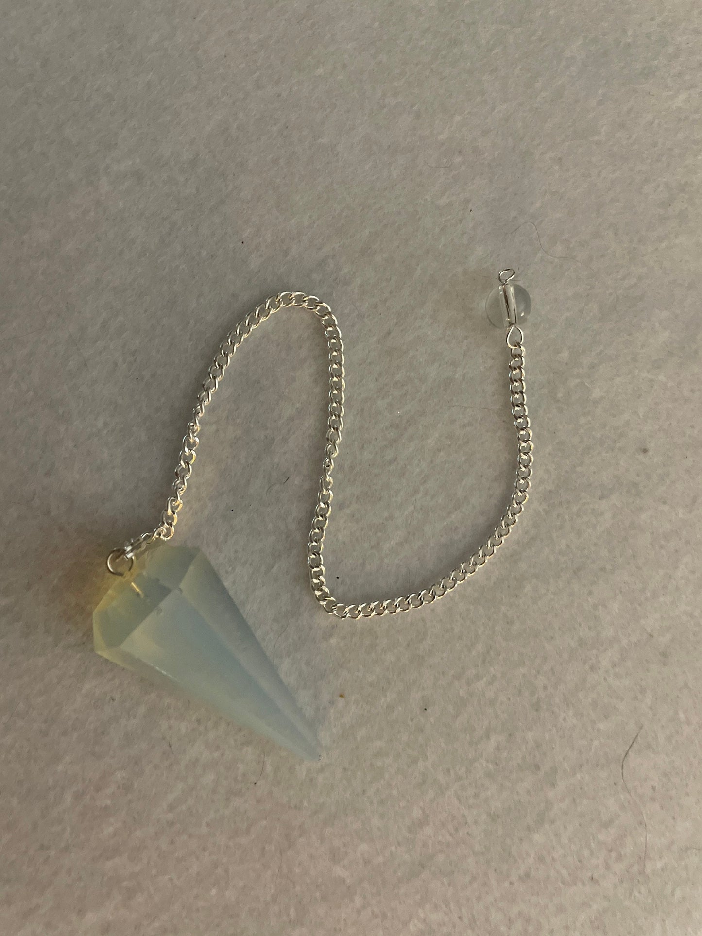 This beautiful  Opalite pendulum is approximately 1.65” and with chain is 8.5”