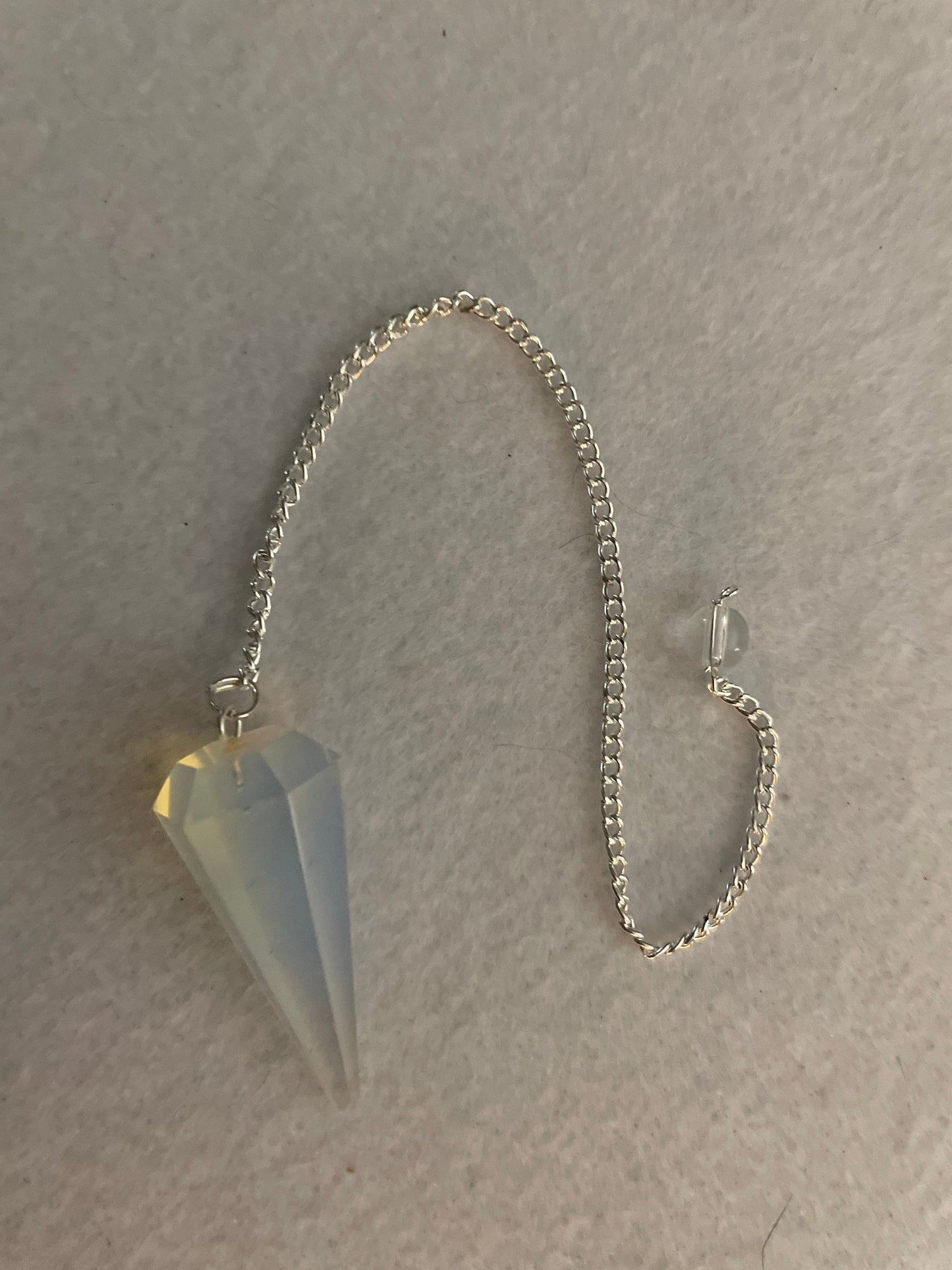 This beautiful  Opalite pendulum is approximately 1.65” and with chain is 8.5”