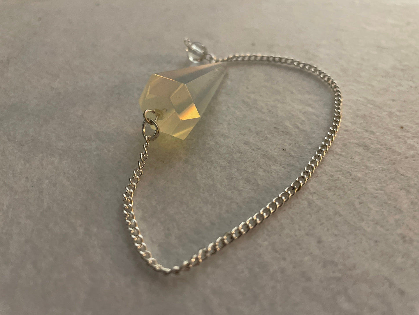 This beautiful  Opalite pendulum is approximately 1.65” and with chain is 8.5”