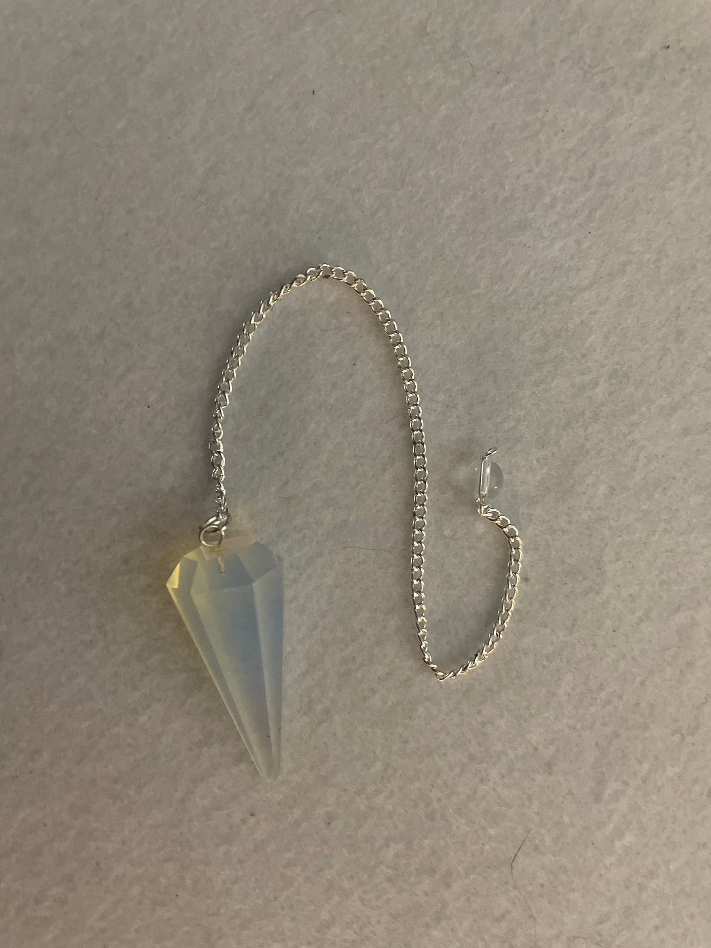 This beautiful  Opalite pendulum is approximately 1.65” and with chain is 8.5”