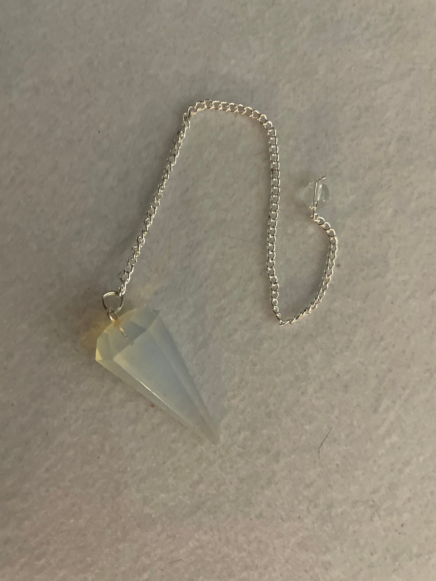 This beautiful  Opalite pendulum is approximately 1.65” and with chain is 8.5”