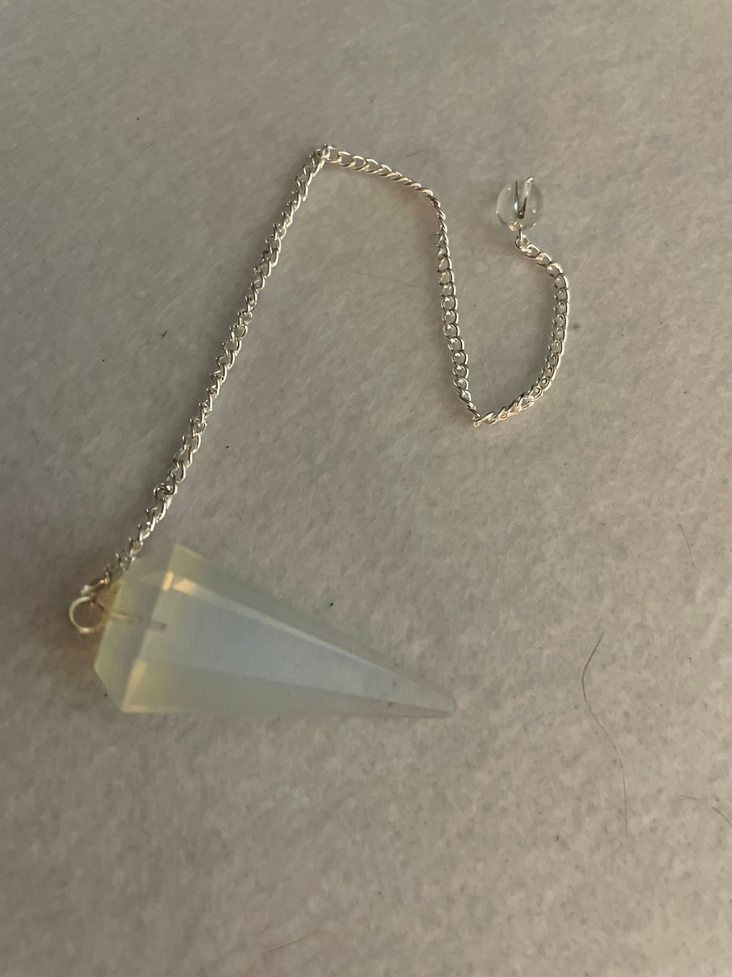 This beautiful  Opalite pendulum is approximately 1.65” and with chain is 8.5”