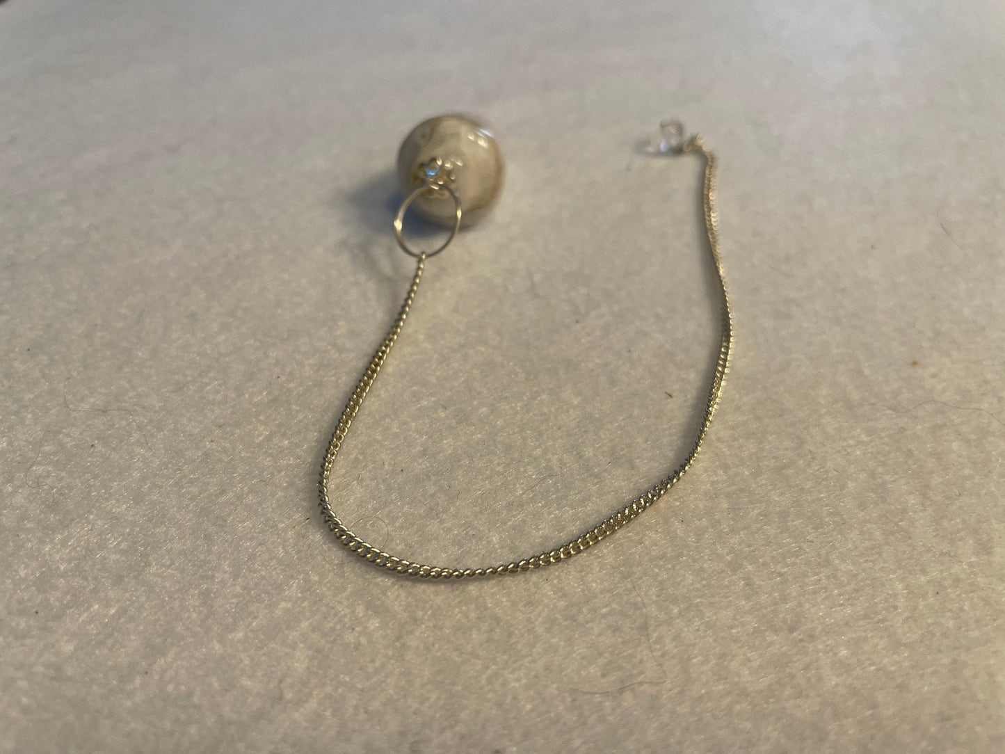 beautiful white Quartz pendulum is approximately 1 1/8” and with chain is 8.5” total length