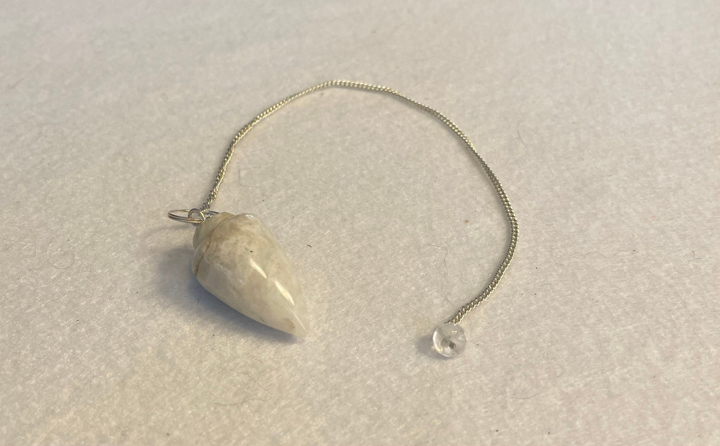 beautiful white Quartz pendulum is approximately 1 1/8” and with chain is 8.5” total length