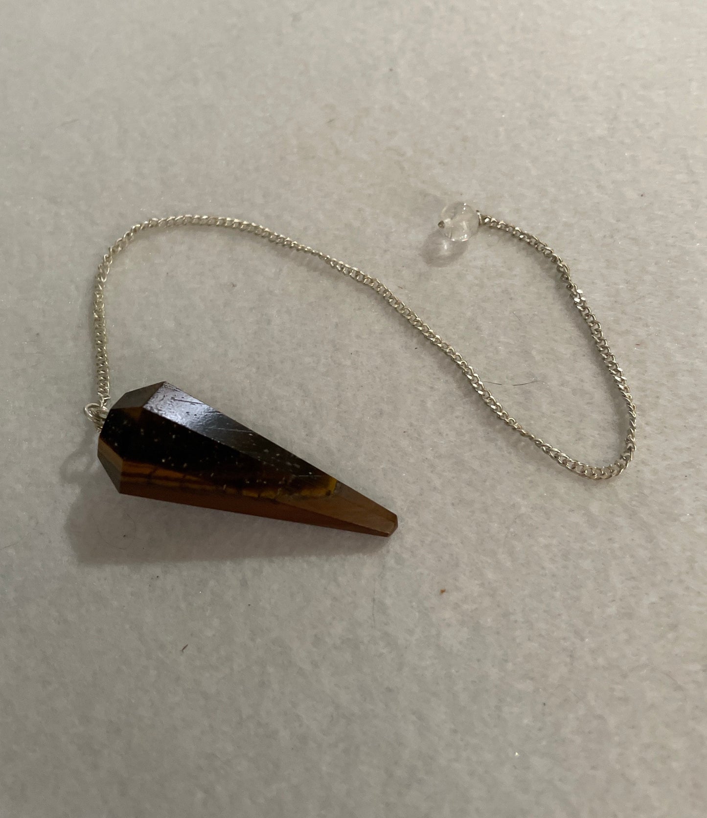 Beautiful Tiger’s Eye pendulum ornaments perfect for dowsing. Hang it in a well lit window, from the ceiling or on the wall!