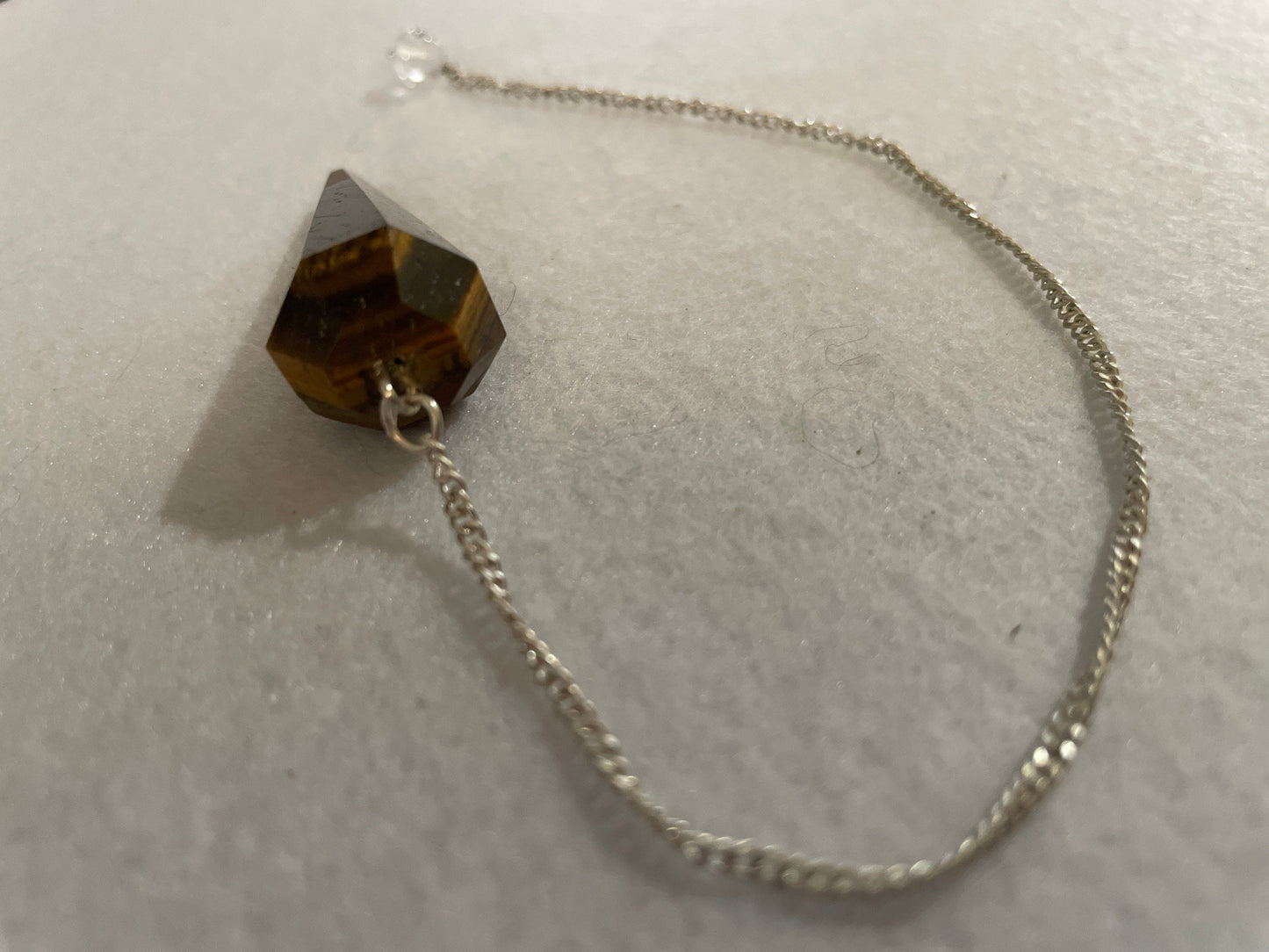 Beautiful Tiger’s Eye pendulum ornaments perfect for dowsing. Hang it in a well lit window, from the ceiling or on the wall!