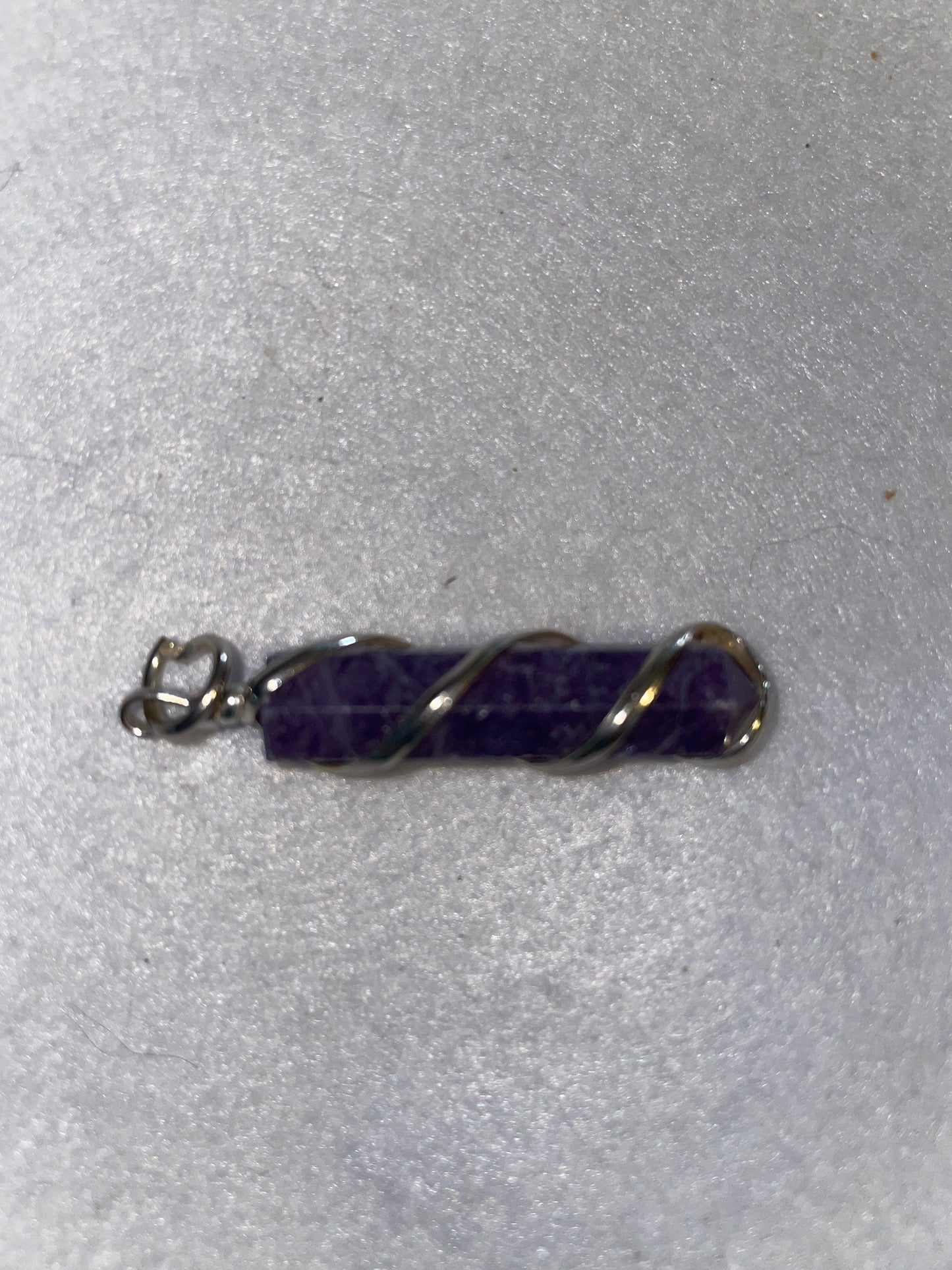 Gorgeous Amethyst Point Pendant is 1.50” and is wrapped in precious silver