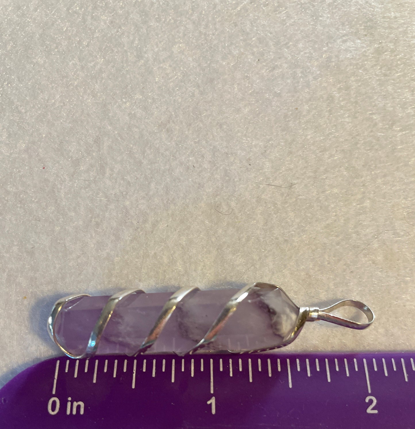 Gorgeous Amethyst Point Pendant is 1.5” and is wrapped in precious silver