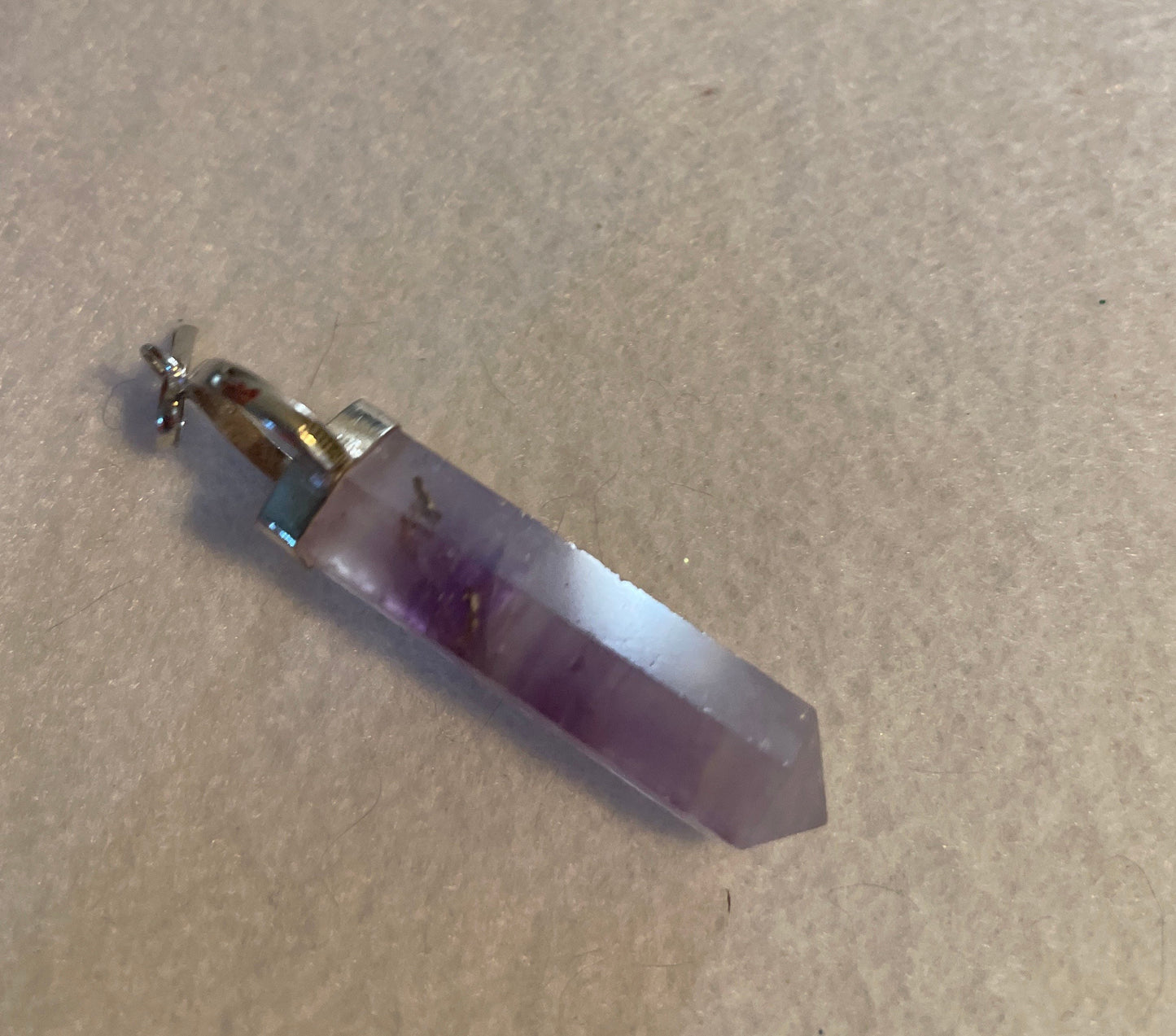 Gorgeous Amethyst Point Pendant is 1.5” and is attached to precious silver.