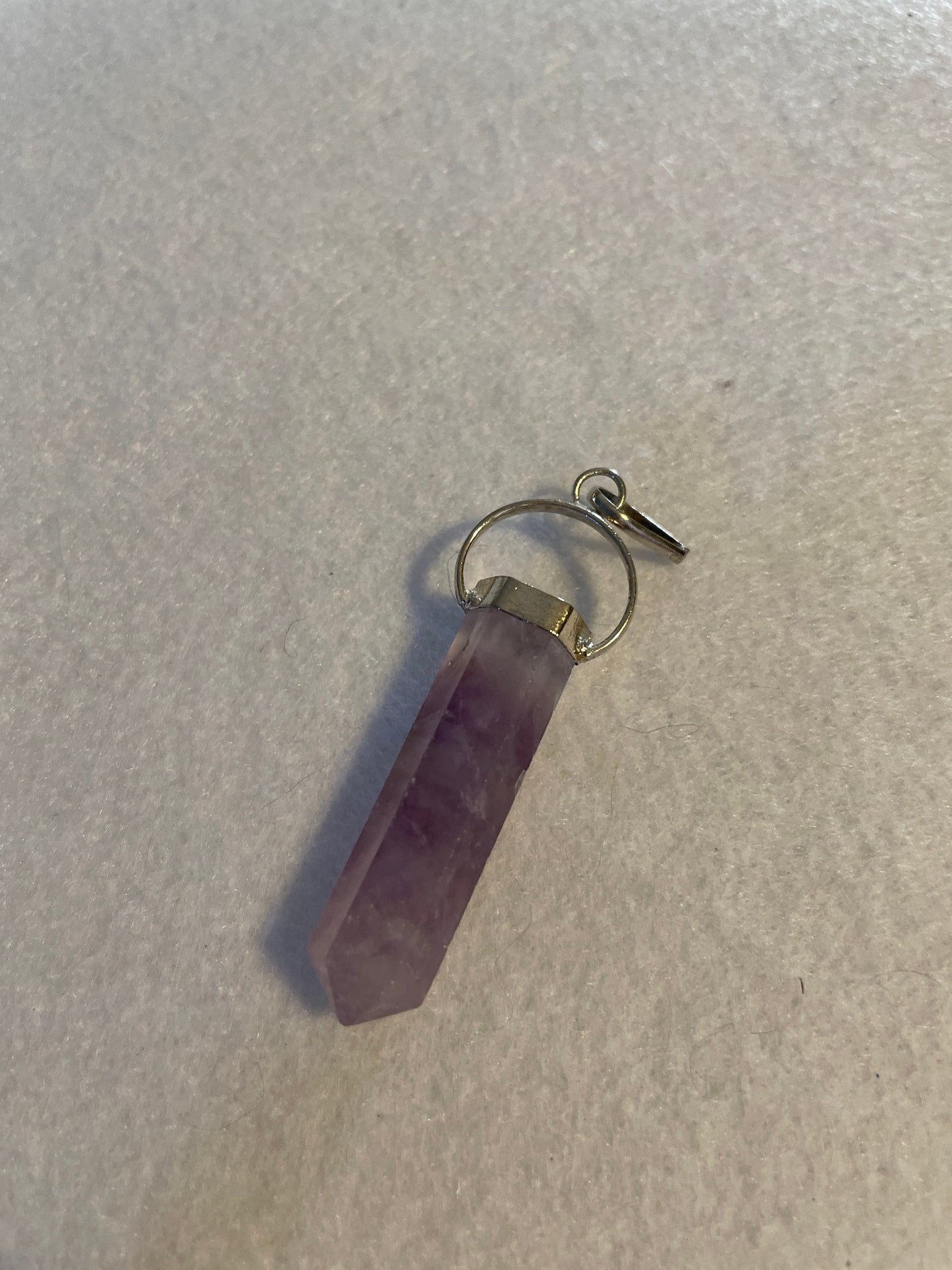 Gorgeous Amethyst Point Pendant is 1.5” and is attached to precious silver.