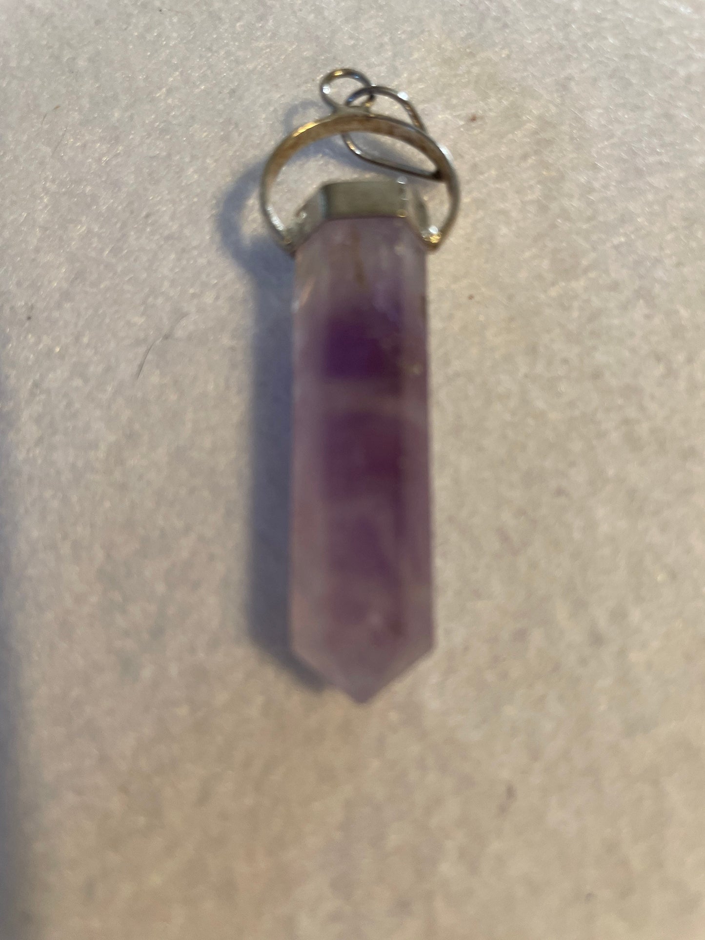 Gorgeous Amethyst Point Pendant is 1.5” and is attached to precious silver.